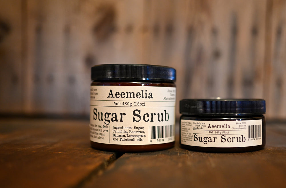 Aeemelia sugar scrub’s unique texture is packed with the nutrients of camellia seed oil and babassu oil to perfectly hydrate your skin. Black screw top lid on 16 oz or 8 oz amber plastic jar with white and black label.  Suitable for all skin types (including sensitive skin).